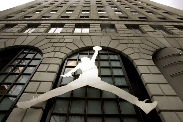 FILE - In this Sept. 29, 2009 file photo, the famous Nike Michael Jordan image graces the front of the Niketown store in downtown Portland, Ore. Basketball legend Michael Jordan is not leaving the Nike Inc. board of directors and his namesake brand, the Air Jordan sneaker, remains with the sports shoe and apparel company. Jordan has never sat on the Nike board of directors, said Mitch Germann, a spokesman for Jordan Brand, which Nike owns. The false claim, which originated on an online satire site, began circulating widely after Nike’s launch of a new ad campaign featuring former San Francisco 49ers quarterback Colin Kaepernick. (AP Photo/Don Ryan, File)