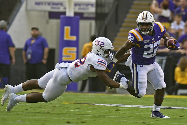 LSU running back Clyde Edwards-Helaire (22) breaks into the open past Northwestern State outside linebacker Landon King (32) in the first half of an NCAA college football game, Saturday, Sept. 14, 2019, in Baton Rouge, La. (AP Photo/Patrick Dennis) LSU running back Clyde Edwards-Helaire (22) breaks into the open past Northwestern State outside linebacker Landon King (32) in the first half of an NCAA college football game, Saturday, Sept. 14, 2019, in Baton Rouge, La. (AP Photo/Patrick Dennis)