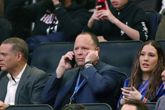 Former player agent and new New York Knicks president Leon Rose, center, takes a phone call during the first quarter of an NBA basketball game against the Houston Rockets in New York, Monday, March 2, 2020. (AP Photo/Kathy Willens)