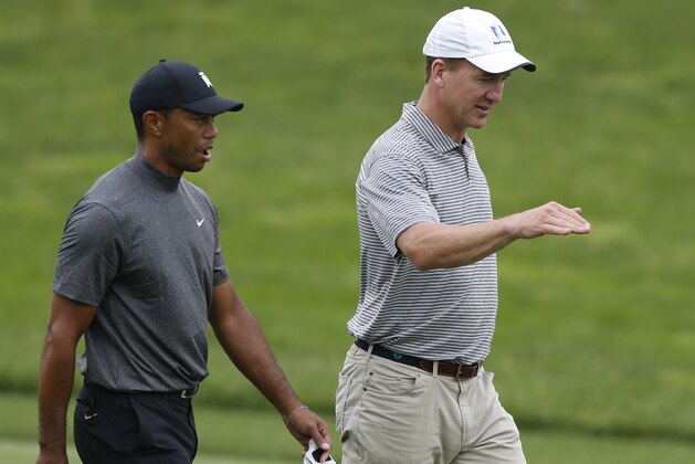 Former NFL player Peyton Manning, right, talks with Tiger Woods while playing in the pro-am round of the Memorial golf tournament Wednesday, May 29, 2019, in Dublin, Ohio. (Jay LaPrete/AP Images for NFL)