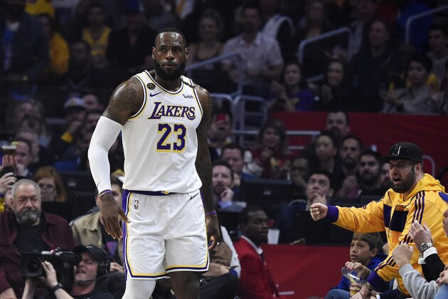 Los Angeles Lakers forward LeBron James walks away from a fan that is reading out to him during the first half of an NBA basketball game against the Los Angeles Clippers Sunday, March 8, 2020, in Los Angeles. (AP Photo/Mark J. Terrill)