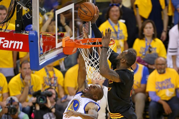 OAKLAND, CA - JUNE 19:  LeBron James #23 of the Cleveland Cavaliers blocks a shot against Andre Iguodala #9 of the Golden State Warriors during Game Seven of the 2016 NBA Finals on June 19, 2016 at ORALCE Arena in Oakland, California. NOTE TO USER: User expressly acknowledges and agrees that, by downloading and or using this Photograph, user is consenting to the terms and conditions of the Getty Images License Agreement. Mandatory Copyright Notice: Copyright 2016 NBAE (Photo by Joe Murphy /NBAE via Getty Images)