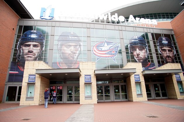 COLUMBUS, OH - MARCH 12:  A Columbus Blue Jackets fan reads a sign on the door stating that all events have been postponed until further notice the Nationwide Arena on March 12, 2020 in Columbus, Ohio. The game between the Columbus Blue Jackets and the Pittsburgh Penguins was canceled after the NHL's decision to suspend the remaining games in the season due to the continuing outbreak of the coronavirus (COVID-19). (Photo by Kirk Irwin/Getty Images)