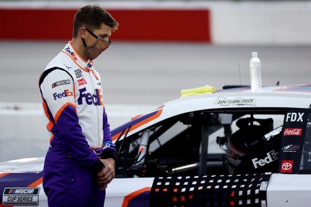 DARLINGTON, SOUTH CAROLINA - MAY 20: Denny Hamlin, driver of the #11 FedEx Delivering Strength Toyota, stands on the grid during the national anthem prior to the NASCAR Cup Series Toyota 500 at Darlington Raceway on May 20, 2020 in Darlington, South Carolina. (Photo by Chris Graythen/Getty Images)