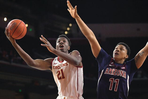 Southern California forward Onyeka Okongwu, left, shoots as Arizona forward Ira Lee defends during the first half of an NCAA college basketball game Thursday, Feb. 27, 2020, in Los Angeles. (AP Photo/Mark J. Terrill)