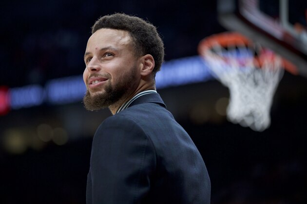 Golden State Warriors guard Stephen Curry smiles from the bench during the second half of an NBA basketball game against the Portland Trail Blazers in Portland, Ore., Monday, Jan. 20, 2020. The Trail Blazers won 129-124 in overtime. (AP Photo/Craig Mitchelldyer)