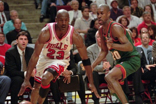 Chicago Bulls' Michael Jordan drives around Seattle SuperSonics' Gary Payton during Game 1 of the NBA Finals Wednesday night, June 5, 1996, in Chicago. The Bulls won 107-90 and the much anticipated matchup of Jordan and Payton in the series opener was well worth the wait. (AP Photo/Beth A. Keiser)