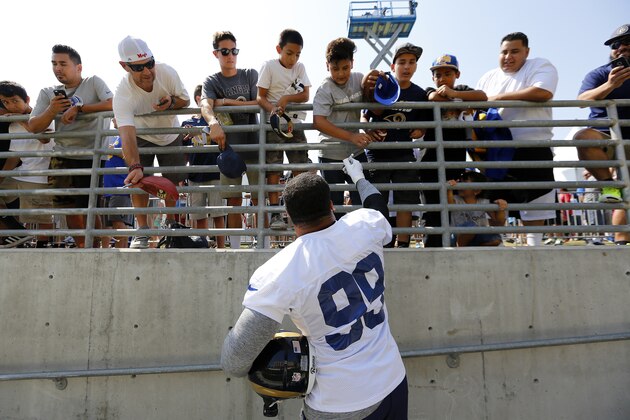 Los Angeles Rams defensive tackle Aaron Donald signs autographs for fans during the NFL football team's training camp, Saturday, July 30, 2016, in Irvine, Calif. (AP Photo/Ryan Kang)