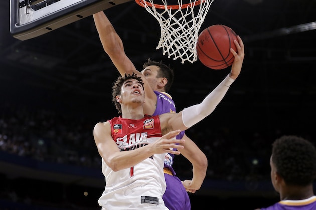 LaMelo Ball of the Illawarra Hawks, left, lays up around Andrew Bogut of the Sydney Kings during their game in the Australian Basketball League in Sydney, Sunday, Nov. 17, 2019. (AP Photo/Rick Rycroft) LaMelo Ball of the Illawarra Hawks, left, lays up around Andrew Bogut of the Sydney Kings during their game in the Australian Basketball League in Sydney, Sunday, Nov. 17, 2019. (AP Photo/Rick Rycroft)