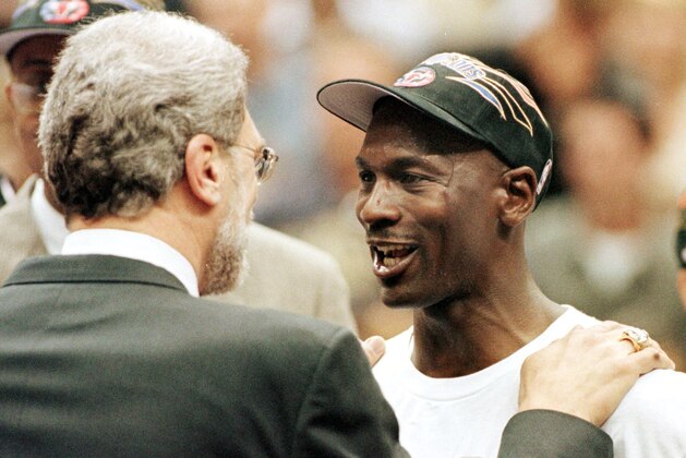 Michael Jordan (R) and Chicago Bulls head coach Phil Jackson (L) congratulate each other 14 June after winning game six of the NBA Finals against the Utah Jazz at the Delta Center in Salt Lake City, UT. The Bulls won the game 87-86 to win their sixth NBA championship.   AFP PHOTO/Jeff HAYNES (Photo by JEFF HAYNES / AFP) (Photo by JEFF HAYNES/AFP via Getty Images)