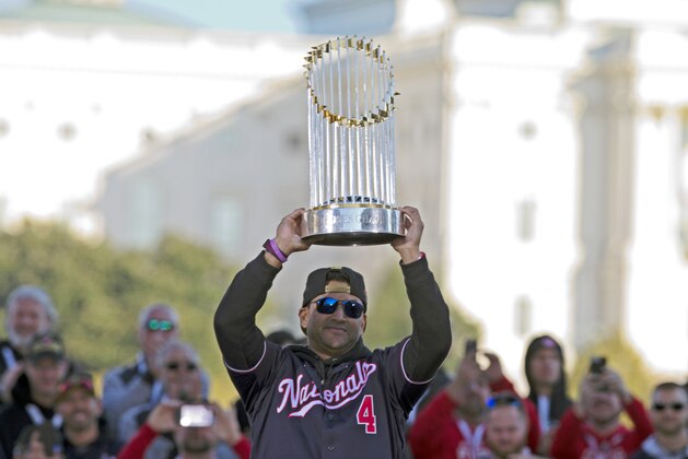Washington Nationals coach Dave Martinez rises the trophy to celebrates the World Series baseball championship during a rally following the parade to celebrate the team's World Series baseball championship over Houston Astros, Saturday, Nov. 2, 2019, in Washington. (AP Photo/Jose Luis Magana)