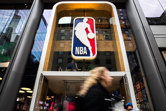 NEW YORK, NY - MARCH 12: A pedestrian walks past the NBA store on 5th Avenue on March 12, 2020 in New York City. The National Basketball Association said they would suspend all games after player Rudy Gobert of the Utah Jazz reportedly tested positive for the Coronavirus (COVID-19). (Photo by Jeenah Moon/Getty Images)