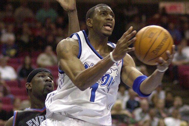 Orlando Magic's Tracy McGrady goes up for a shot and misses late in the fourth quarter while being guarded by Cleveland Cavaliers' Jumaine Jones, left, in Orlando, Fla. Wednesday Jan. 29, 2003. The Magic beat the Cavaliers 113-108 and McGrady had 31 points.(AP Photo/Peter Cosgrove)