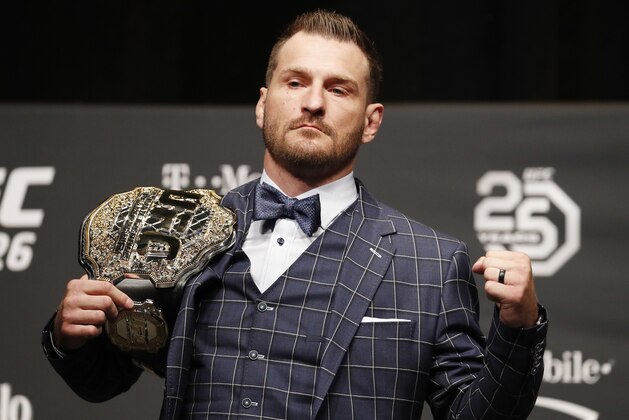 FILE - In this July 5, 2018, file photo, Stipe Miocic poses during a news conference for UFC 226 in Las Vegas. Heavyweight champion Stipe Miocic welcomes the UFC's planned return. The fighter and firefighter does have some worries, though. (AP Photo/John Locher, File)