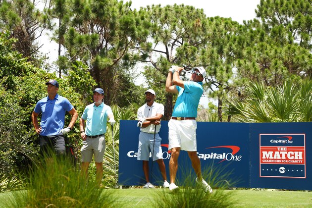 HOBE SOUND, FLORIDA - MAY 23:  Phil Mickelson plays a shot as NFL player Tom Brady of the Tampa Bay Buccaneers, former NFL player Peyton Manning and Tiger Woods look on during a practice round for The Match: Champions For Charity at Medalist Golf Club on May 23, 2020 in Hobe Sound, Florida. (Photo by Mike Ehrmann/Getty Images for The Match)