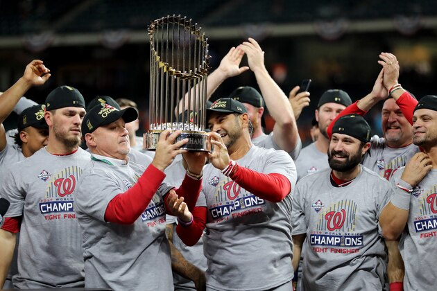 HOUSTON, TEXAS - OCTOBER 30:  Mike Rizzo Washington Nationals hoists the Commissioners Trophy after defeating the Houston Astros 6-2 in Game Seven to win the 2019 World Series in Game Seven of the 2019 World Series at Minute Maid Park on October 30, 2019 in Houston, Texas. (Photo by Elsa/Getty Images)