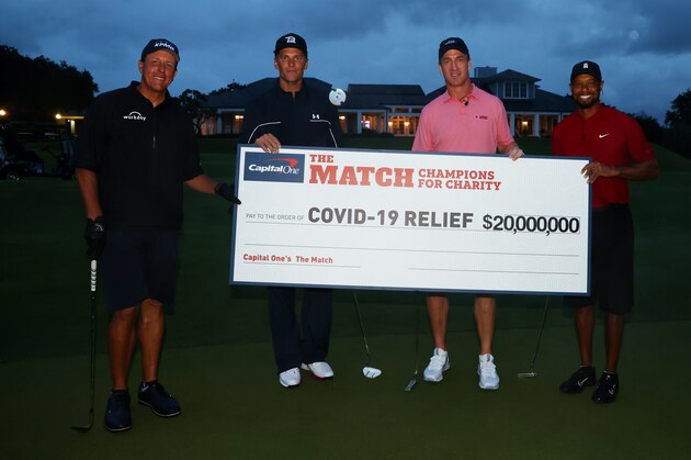 HOBE SOUND, FLORIDA - MAY 24: Tiger Woods and former NFL player Peyton Manning celebrate defeating Phil Mickelson and NFL player Tom Brady of the Tampa Bay Buccaneers on the 18th green during The Match: Champions For Charity at Medalist Golf Club on May 24, 2020 in Hobe Sound, Florida. (Photo by Mike Ehrmann/Getty Images for The Match)