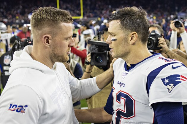 HOUSTON, TX - DECEMBER 1:  J.J. Watt #99 of the Houston Texans talks after the game on the field while surrounded by photographers to Tom Brady #12 of the New England Patriots at NRG Stadium on December 1, 2019 in Houston, Texas.  The Texans defeated the Patriots 28-22.  (Photo by Wesley Hitt/Getty Images)