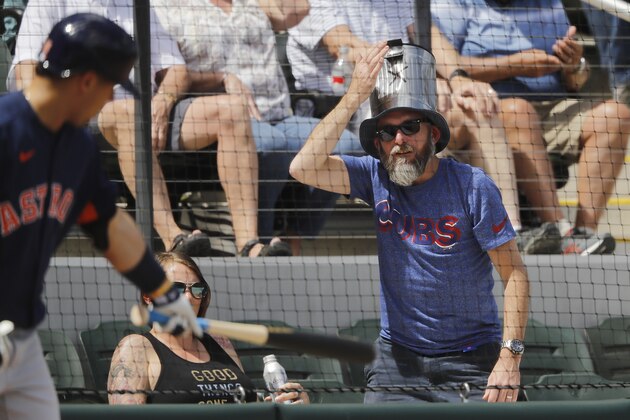 NORTH PORT, FLORIDA - MARCH 10:  A fan bangs on his hat in the shape of a trash can as Aledmys Diaz #16 of the Houston Astros looks on from the on deck circle against the Atlanta Braves during the fourth inning of a Grapefruit League spring training game at CoolToday Park on March 10, 2020 in North Port, Florida. (Photo by Michael Reaves/Getty Images)