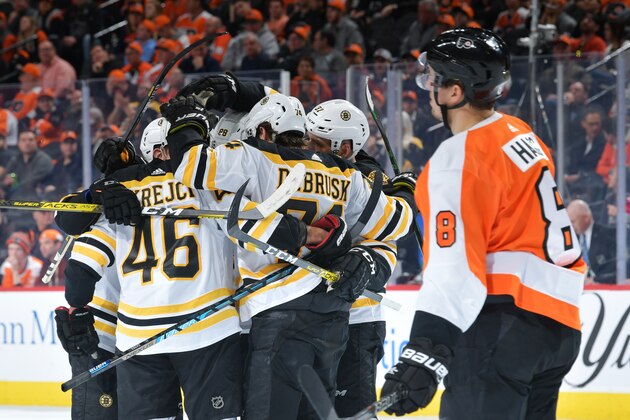 PHILADELPHIA, PA - MARCH 10: Matt Grzelcyk #48, David Krejci #46, David Pastrnak #88,Torey Krug #47 and Patrice Bergeron #37 of the Boston Bruins celebrate a goal as Robert Hagg #8 of the Philadelphia Flyers skates by in the second period at Wells Fargo Center on March 10, 2020 in Philadelphia, Pennsylvania. (Photo by Drew Hallowell/Getty Images)