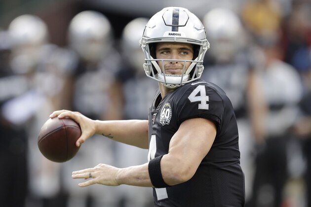 Oakland Raiders quarterback Derek Carr (4) passes against the Tennessee Titans during the first half of an NFL football game in Oakland, Calif., Sunday, Dec. 8, 2019. (AP Photo/Ben Margot)