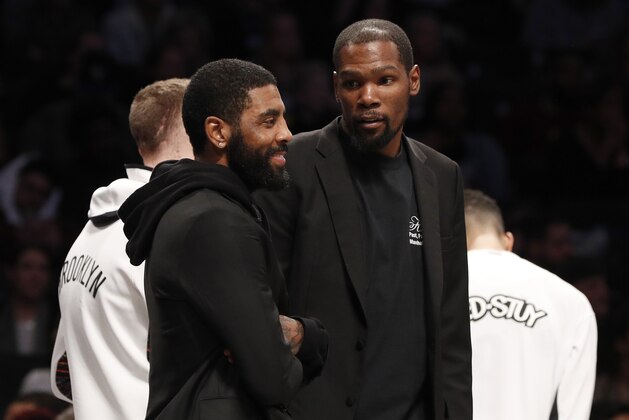 NEW YORK, NEW YORK - JANUARY 10:  (NEW YORK DAILIES OUT)  Kyrie Irving #11 (L) and Kevin Durant #7 of the Brooklyn Nets during a game against the Miami Heat at Barclays Center on January 10, 2020 in New York City. The Nets defeated the Heat 117-113.
NOTE TO USER: User expressly acknowledges and agrees that, by downloading and or using this photograph, User is consenting to the terms and conditions of the Getty Images License Agreement. (Photo by Jim McIsaac/Getty Images)
