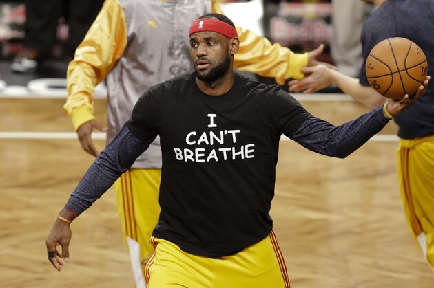 FILE - In this Dec. 8, 2014 file photo, Cleveland Cavaliers' LeBron James wears a T-shirt reading