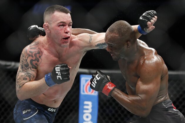 Kamaru Usman, right, fights Colby Covington in a mixed martial arts welterweight championship bout at UFC 245, Saturday, Dec. 14, 2019, in Las Vegas. (AP Photo/John Locher)