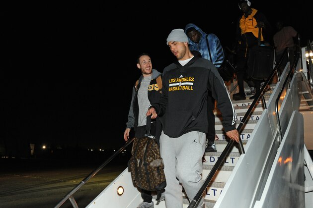 INGLEWOOD, CA - APRIL 7:  Marcelo Huertas #9 and Robert Sacre #50 of the Los Angeles Lakers exit the plane as they arrive in New Orleans, Louisiana from Inglewood, California on April 7, 2016.  NOTE TO USER: User expressly acknowledges and agrees that, by downloading and or using this photograph, User is consenting to the terms and conditions of the Getty Images License Agreement. Mandatory Copyright Notice: Copyright 2016 NBAE  (Photo by Andrew D. Bernstein/NBAE via Getty Images)