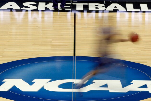 FILE - In this March 14, 2012, file photo, a player runs across the NCAA logo during practice at the NCAA tournament college basketball in Pittsburgh. The NCAA Board of Governors took the first step Tuesday, Oct. 29, 2019, toward allowing athletes to cash in on their fame, voting unanimously to clear the way for the amateur athletes to