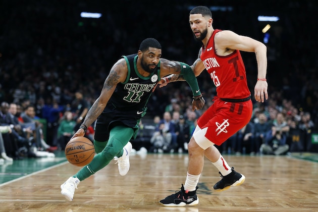 Boston Celtics' Kyrie Irving (11) drives past Houston Rockets' Austin Rivers (25) during the first half of an NBA basketball game in Boston, Sunday, March 3, 2019. (AP Photo/Michael Dwyer)