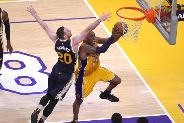 Los Angeles Lakers forward Kobe Bryant, right, shoots as Utah Jazz forward Gordon Hayward defends during the second half of an NBA basketball game, Wednesday, April 13, 2016, in Los Angeles. Bryant scored 60 points in his final NBA game as the Lakers won 101-96. (AP Photo/Mark J. Terrill)
