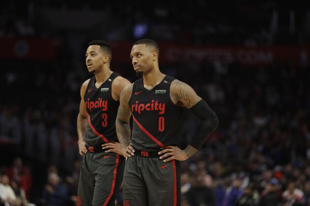 Portland Trail Blazers' Damian Lillard (0) and CJ McCollum (3) during the second half of an NBA basketball game against the Los Angeles Clippers Monday, Dec. 17, 2018, in Los Angeles. (AP Photo/Marcio Jose Sanchez)