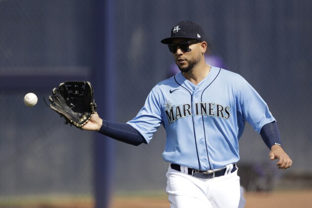 Seattle Mariners right fielder Carlos Gonzalez catches a ball during the fifth inning of a spring training baseball game against the Colorado Rockies Monday, March 2, 2020, in Peoria, Ariz. (AP Photo/Charlie Riedel)