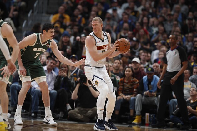 Denver Nuggets forward Mason Plumlee (7) and Milwaukee Bucks forward Ersan Ilyasova (7) in the second half of an NBA basketball game Monday, March 9, 2020, in Denver. The Nuggets won 109-95. (AP Photo/David Zalubowski)