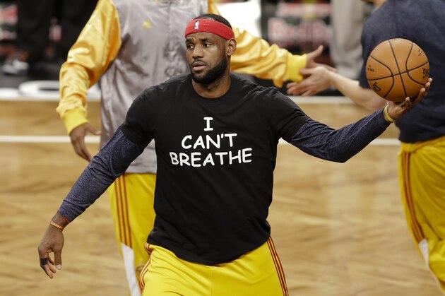 FILE - In this Dec. 8, 2014 file photo, Cleveland Cavaliers' LeBron James wears a T-shirt reading