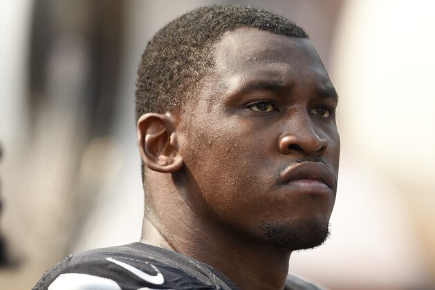 OAKLAND, CA - SEPTEMBER 13:  Aldon Smith #99 of the Oakland Raiders looks on from the bench against the Cincinnati Bengals during their NFL game at the O.co Coliseum on September 13, 2015 in Oakland, California.  (Photo by Thearon W. Henderson/Getty Images)