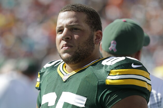 Green Bay Packers guard Lane Taylor (65) stands on the sidelines during the second half of an NFL football game against the Miami Dolphins, Sunday, Oct. 12, 2014, in Miami Gardens, Fla. (AP Photo/Lynne Sladky)