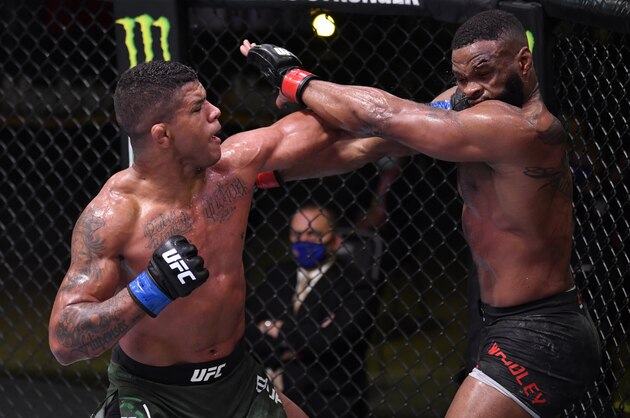 LAS VEGAS, NEVADA - MAY 30: In this handout provided by UFC,  (L-R) Gilbert Burns of Brazil punches Tyron Woodley in their welterweight fight during the UFC Fight Night event at UFC APEX on May 30, 2020 in Las Vegas, Nevada. (Photo by Jeff Bottari/Zuffa LLC via Getty Images)