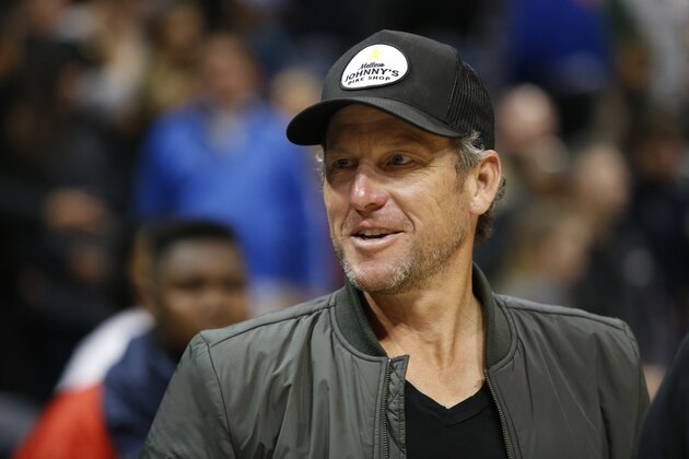 FILE - In this March 3, 2017, file photo, former cyclist Lance Armstrong stands on the court after an NBA basketball game between the Cleveland Cavaliers and Atlanta Hawks in Atlanta. Authorities in Belgium have criticized an invitation to disgraced former cyclist Lance Armstrong as a special guest at next year's Tour of Flanders cycling classic. Organizers said Thursday, Dec. 14, 2017, that he will be a keynote speaker at an event entitled the FILE - In this March 3, 2017, file photo, former cyclist Lance Armstrong stands on the court after an NBA basketball game between the Cleveland Cavaliers and Atlanta Hawks in Atlanta. Authorities in Belgium have criticized an invitation to disgraced former cyclist Lance Armstrong as a special guest at next year's Tour of Flanders cycling classic. Organizers said Thursday, Dec. 14, 2017, that he will be a keynote speaker at an event entitled the