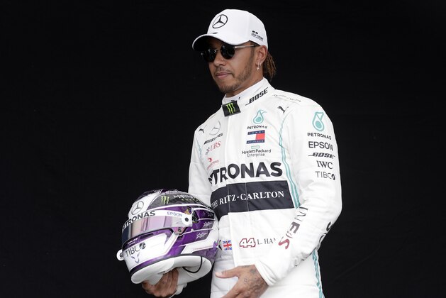Mercedes driver Lewis Hamilton of Britain poses for a photo at the Australian Formula One Grand Prix in Melbourne, Thursday, March 12, 2020. (AP Photo/Rick Rycroft)