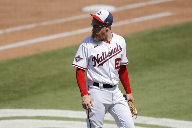 Washington Nationals pitcher Sean Doolittle looks back as he exits the game during the fifth inning of a spring training baseball game against the New York Yankees, Thursday, March 12, 2020, in West Palm Beach, Fla. (AP Photo/Julio Cortez)