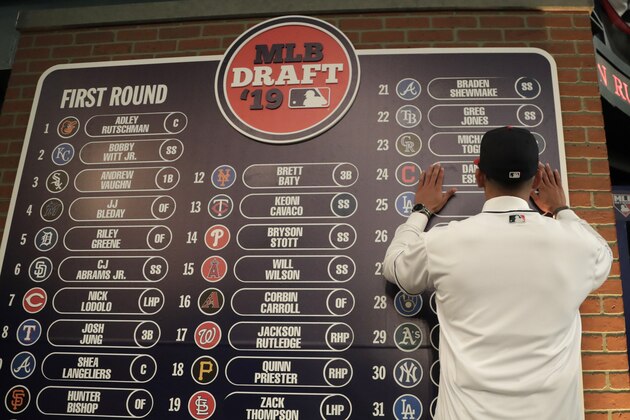 Daniel Espino, a right handed pitcher from the Georgia Premier Academy, in Statesboro, Ga., places his name on the draft board after being selected No. 24 by the Cleveland Indians in the first round of the Major League Baseball draft, Monday, June 3, 2019, in Secaucus, N.J. (AP Photo/Julio Cortez)