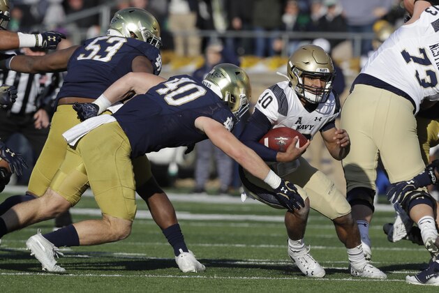Navy quarterback Malcolm Perry (10) is tackled by Notre Dame linebacker Drew White (40) during the first half of an NCAA college football game, Saturday, Nov. 16, 2019, in South Bend, Ind. (AP Photo/Darron Cummings) Navy quarterback Malcolm Perry (10) is tackled by Notre Dame linebacker Drew White (40) during the first half of an NCAA college football game, Saturday, Nov. 16, 2019, in South Bend, Ind. (AP Photo/Darron Cummings)