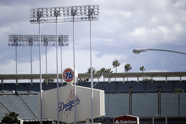 The exterior of Dodgers Stadium, home of the Los Angeles Dodgers is seen Wednesday, March 25, 2020, in Los Angeles. There will be empty ballparks on what was supposed to be Major League Baseball's opening day, with the start of the Major League Baseball regular season indefinitely on hold because of the coronavirus pandemic. (AP Photo/Marcio Jose Sanchez) The exterior of Dodgers Stadium, home of the Los Angeles Dodgers is seen Wednesday, March 25, 2020, in Los Angeles. There will be empty ballparks on what was supposed to be Major League Baseball's opening day, with the start of the Major League Baseball regular season indefinitely on hold because of the coronavirus pandemic. (AP Photo/Marcio Jose Sanchez)