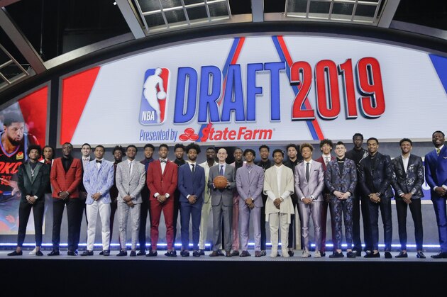 Prospective NBA draft picks pose for a group photo with NBA Commissioner Adam Silver, with basketball, before the NBA draft Thursday, June 20, 2019, in New York. (AP Photo/Julio Cortez)