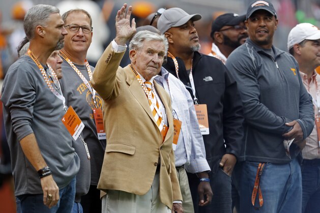 Former Tennessee head football coach Johnny Majors waves to fans as he and members of the 1998 football team are introduced in the first half of an NCAA college football game against Mississippi State, Saturday, Oct. 12, 2019, in Knoxville, Tenn. (AP Photo/Wade Payne)