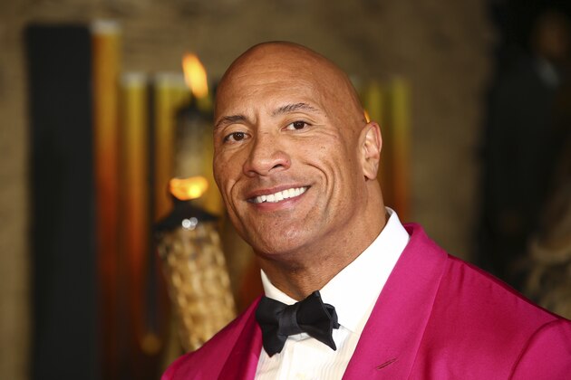FILE - In this Dec. 5, 2019 file photo, actor Dwayne Johnson poses for photographers upon arrival at the premiere of the film 'Jumanji The Next Level', in central London.   Johnson will revisit his younger years in a new NBC comedy series called “The Rock,” which is the retired pro wrestler's nickname. NBC said Saturday, Jan. 11, 2020  that it's ordered 11 episodes of the show inspired by Johnson, who will appear and also serve as an executive producer.  (Photo by Joel C Ryan/Invision/AP)