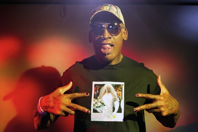 In this Monday, Sept. 9, 2019, photo, former NBA star Dennis Rodman poses wearing a T-shirt depicting himself in a wedding dress at a 1996 book promo event, in Los Angeles. After a career of spectacular highs and very public lows, Dennis Rodman keeps finding new ways to surprise. The former NBA star, featured in a new ESPN documentary, weighs in on his personal brand, bisexual athletes, North Korea and Trump. Rodman's spectacular personal highs and very public lows are the subject of the new ESPN
