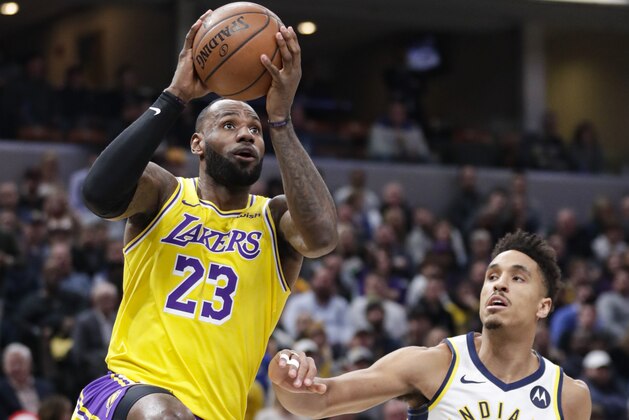 Los Angeles Lakers forward LeBron James (23) shoots over Indiana Pacers guard Malcolm Brogdon (7) during the first half of an NBA basketball game in Indianapolis, Tuesday, Dec. 17, 2019. (AP Photo/Michael Conroy)